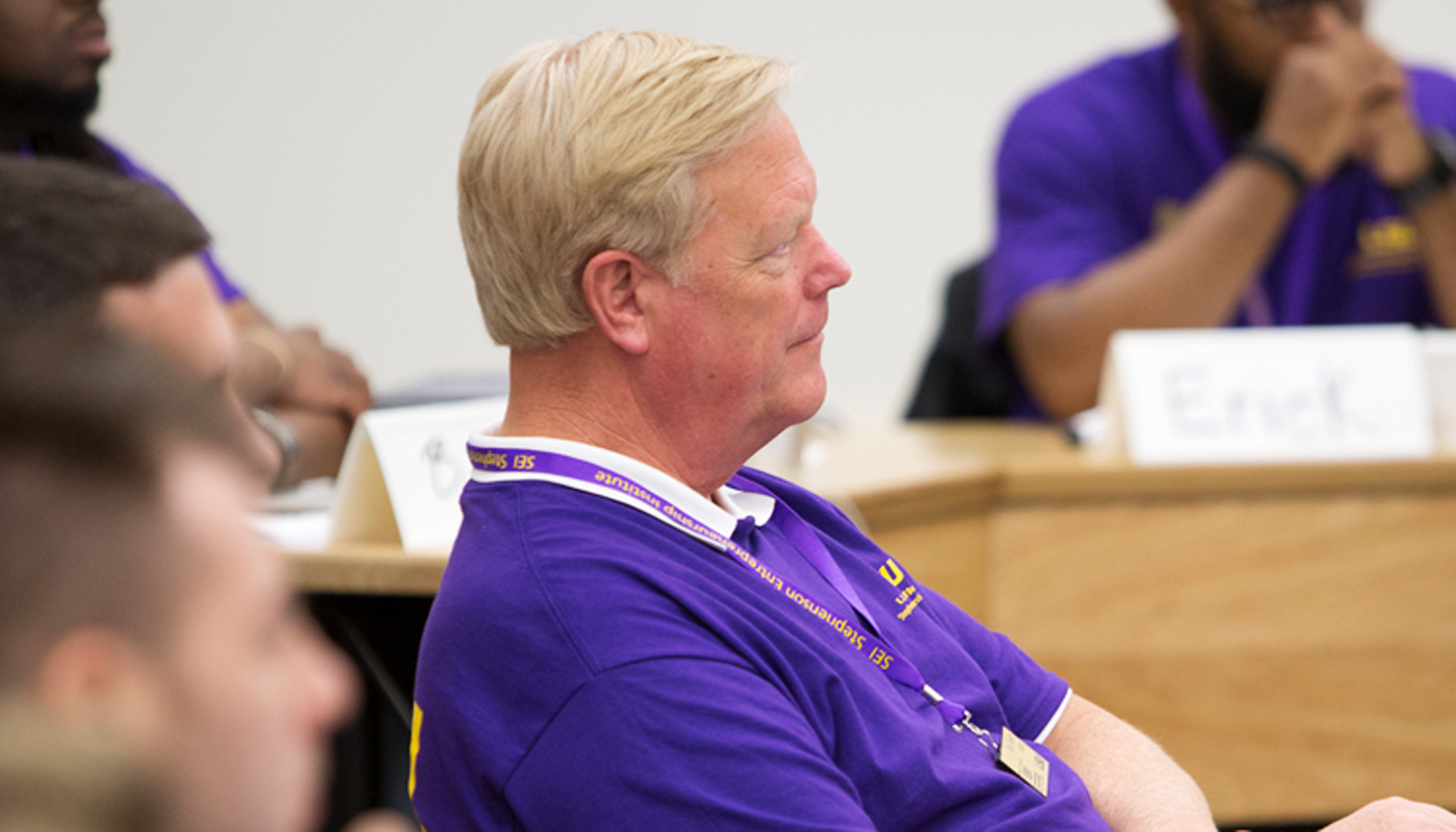 Man in purple shirt in classroom