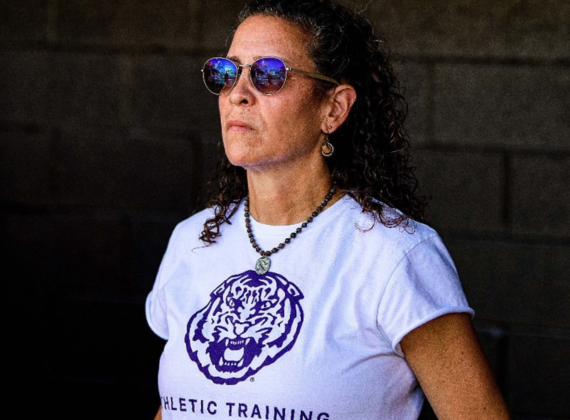 Shelly Mullenix wearing sunglasses and a shirt with an LSU Tiger that says Athletic Training