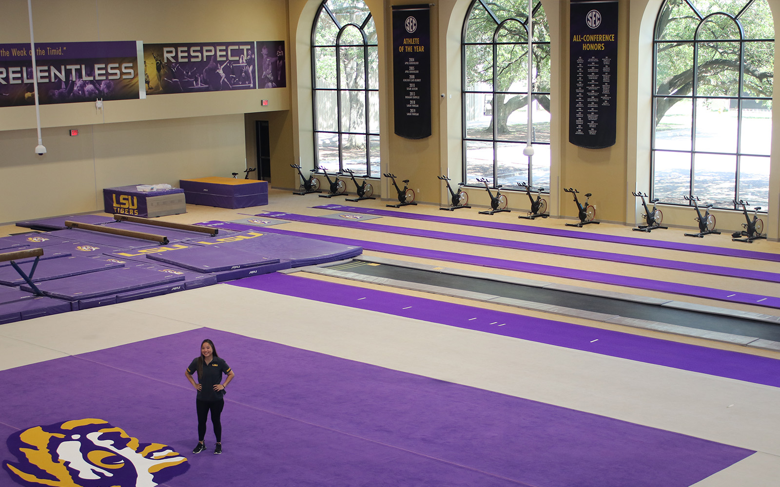 Student standing in LSU gymnastics practice space