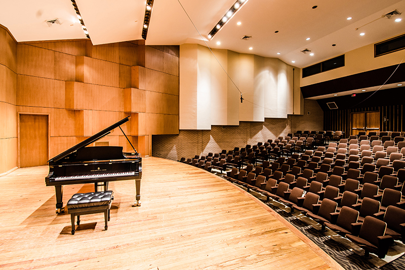 piano on stage in a recital hall