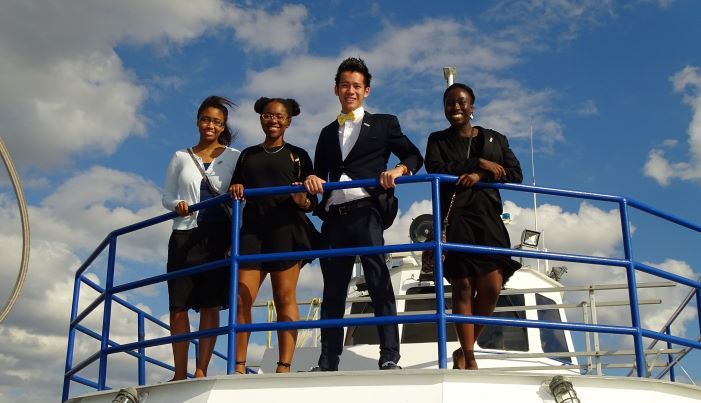 4 students on the deck of a boat in formal wear