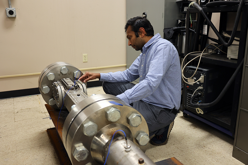 Shyam Menon inspecting machine