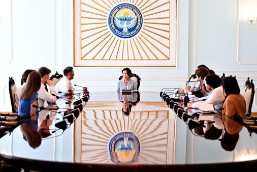 Many people at a conference room desk