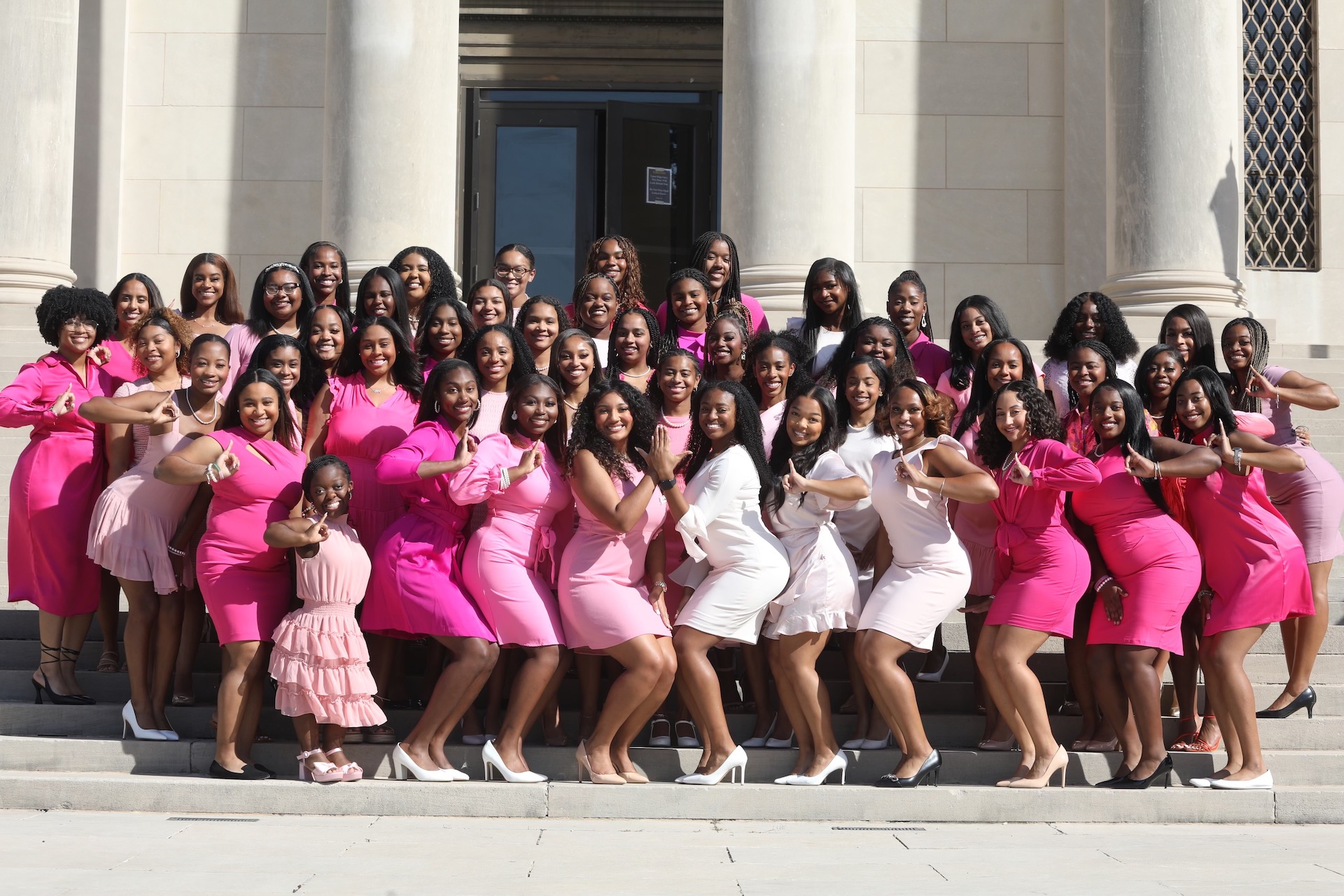 aka members posing with pink dresses