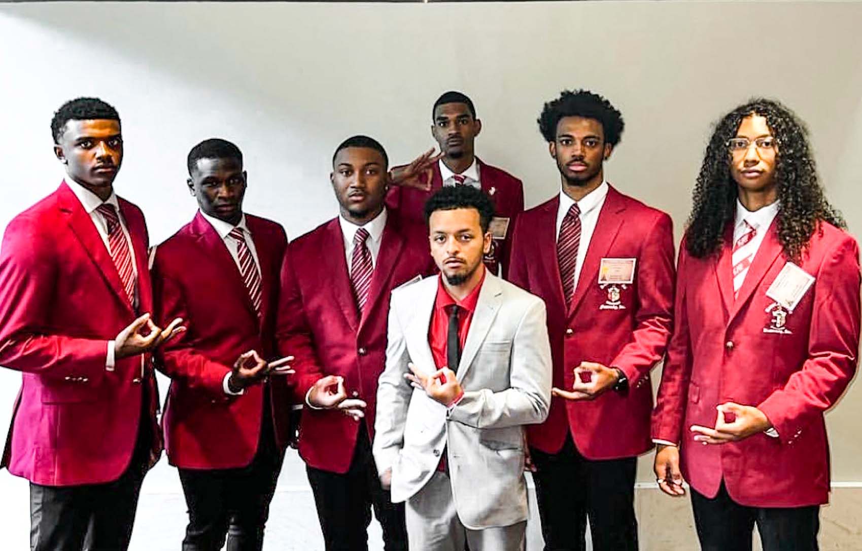 nphc members pose in red jackets