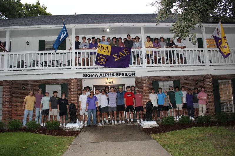 SAE members in front of house