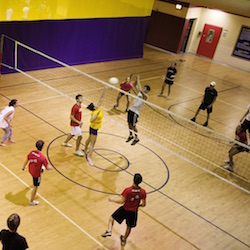 Students play volleyball during gym.