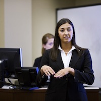 Students give presentations in business management classroom.