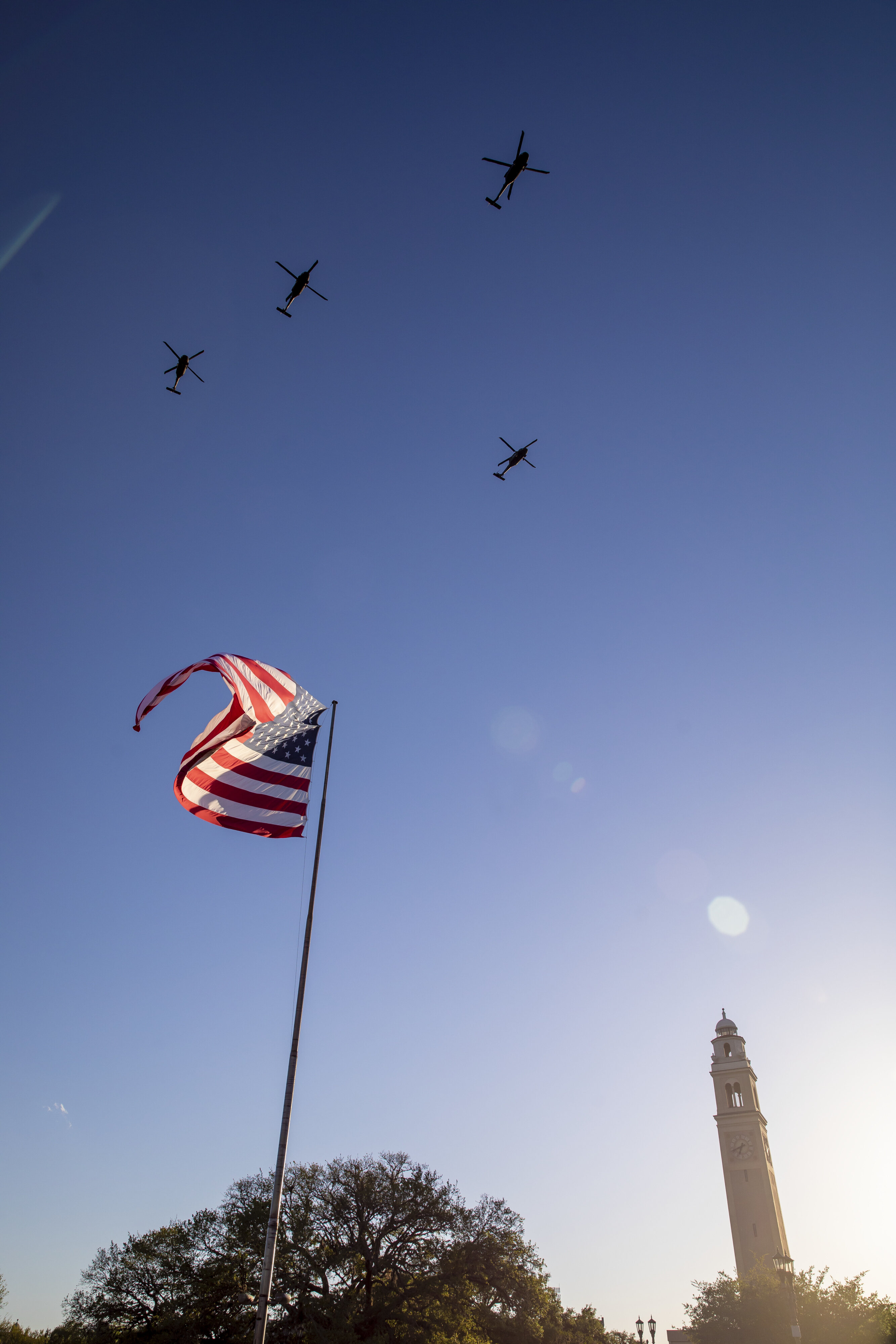 USA flag with military helicopters overhead